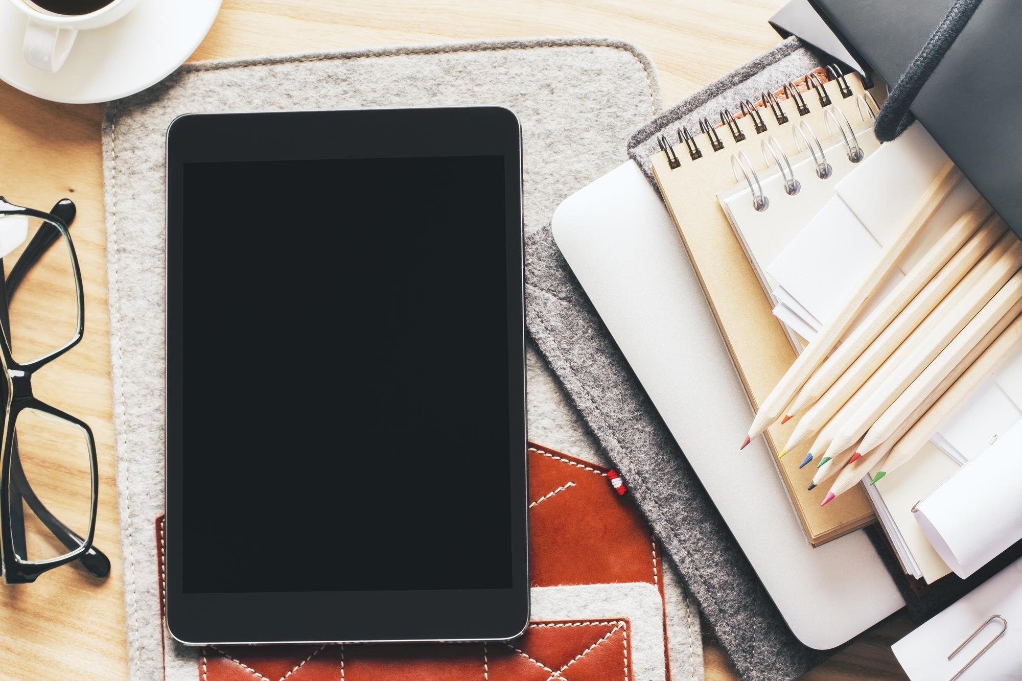 Flatlay: Kursunterlagen, Tablet und Edelstifte
